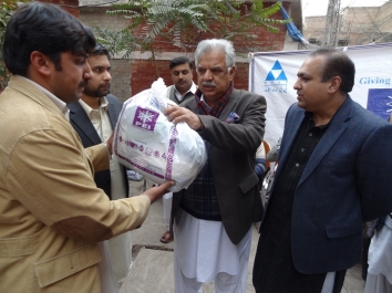 PML-N general secretary Iqbal Zafar Jhagra and chief executive of the PEI distributes relief items among beneficiaries..JPGPML-N general secretary Iqbal Zafar Jhagra and chief executive of the PEI distributes relief items among beneficiaries.